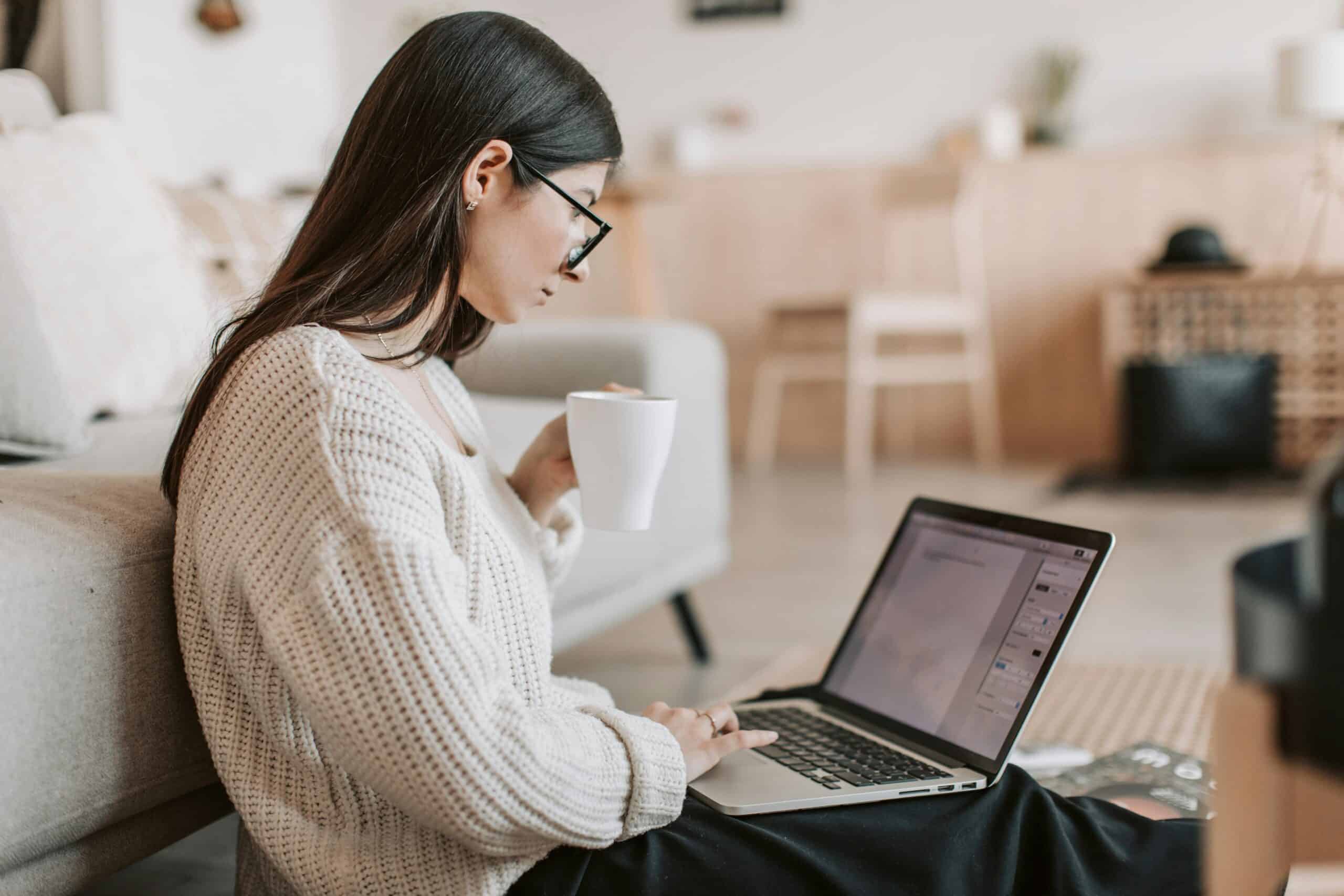 girl sips coffee while working on computer Salesforce